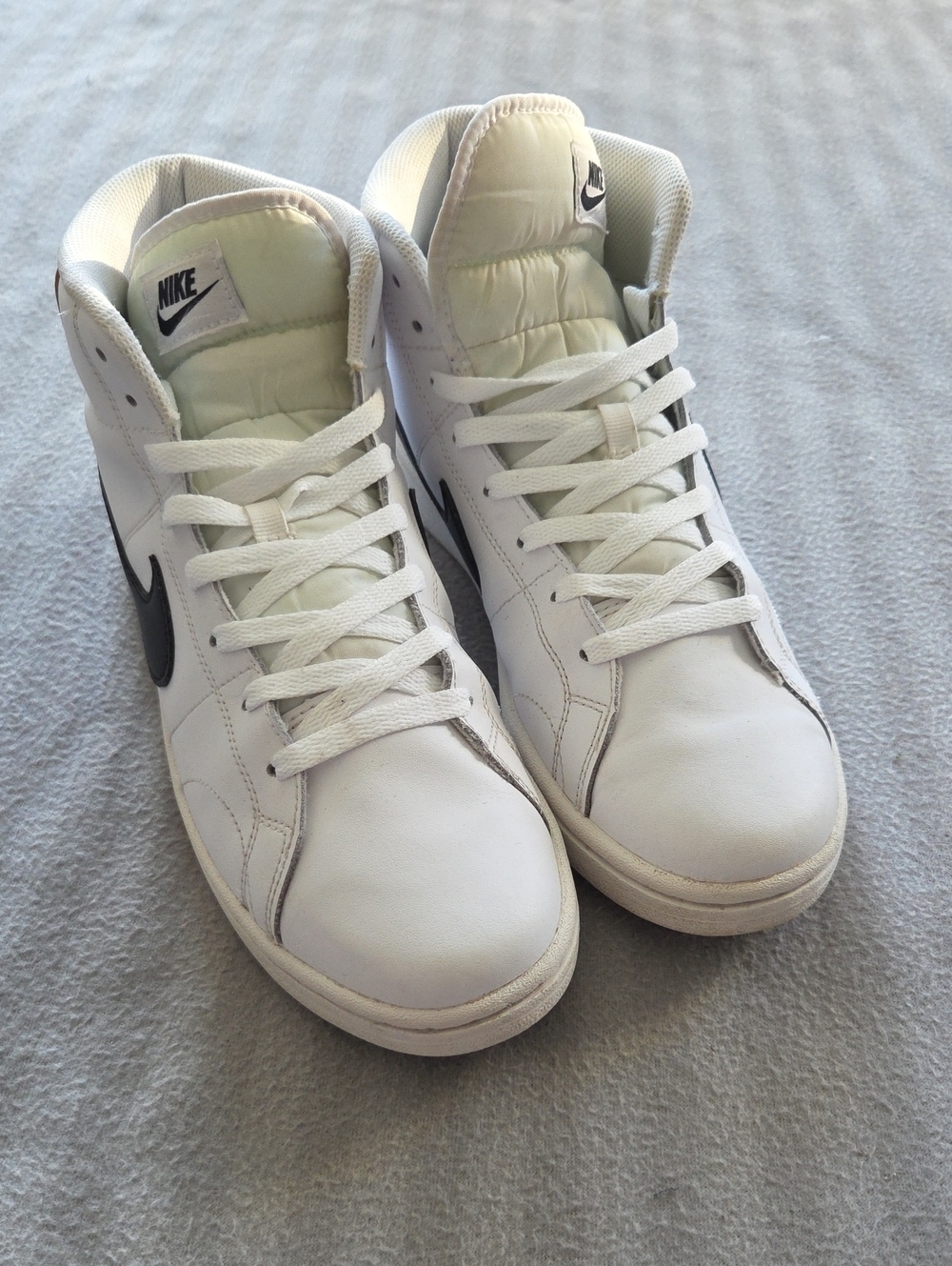 Nike White Mid-Top Sneakers with Black Swoosh
